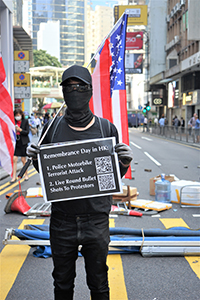 Protester denouncing police violence, Queen's Road Central, 11 November 2019