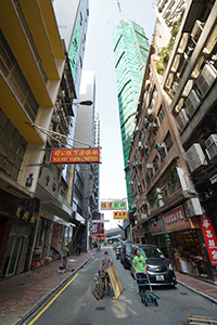 Man holding the end of a long rope at a construction site on Wing Lok Street, Sheung Wan, 19 November 2019