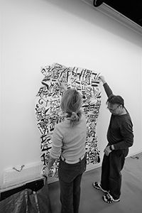 Artist Chak installing an artwork by Kwok Mang Ho in the Visual Arts Centre, Kennedy Road, 11 December 2019