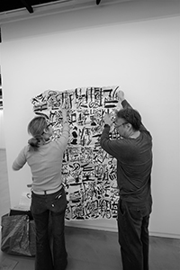 Artist Chak installing an artwork by Kwok Mang Ho in the Visual Arts Centre, Kennedy Road, 11 December 2019