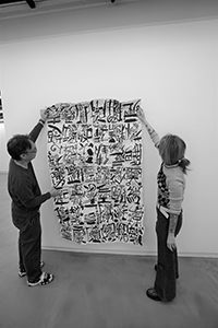Artist Chak installing an artwork by Kwok Mang Ho in the Visual Arts Centre, Kennedy Road, 11 December 2019
