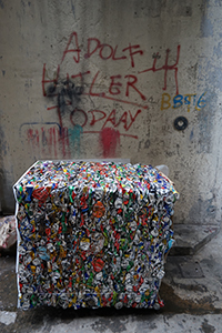 Adolf Hitler graffiti and a block of aluminum cans awaiting recycling, in a back alley in Sheung Wan, Hong Kong Island, 21 December 2019