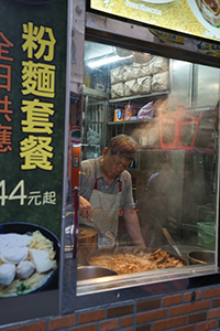 Cook seen through a restaurant window, Kowloon, 26 December 2019