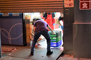 Staff closing down Kai Bo Food Supermarket, Sai Ying Pun, due to nearby street disturbances, 28 July 2019