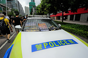 Protest posters placed on a police vehicle, anti-extradition bill march from Tsim Sha Tsui to West Kowloon Station, Kowloon Park Drive, 7 July 2019