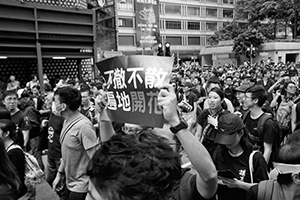 Protester with a sign, anti-extradition bill march from Tsim Sha Tsui to West Kowloon Station, Kowloon Park Drive, 7 July 2019