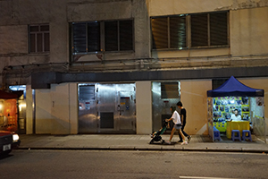People passing by fortune telling booths, Temple Street, Yau Ma Tei, 7 July 2019