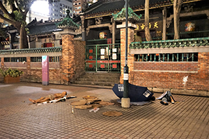 Homeless men sleeping outside the Tin Hau Temple, Temple Street, Yau Ma Tei, 7 July 2019