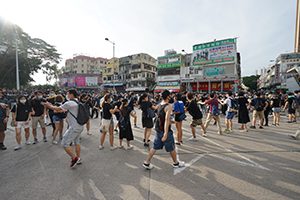 Protesters transferring materials in a line, 'Reclaim Sheung Shui' protest against parallel traders from China, Lung Sum Avenue, 13 July 2019