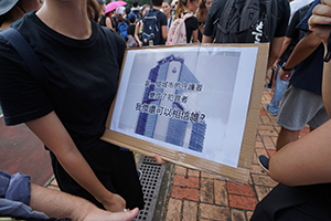 Protester with a sign, in a crowd gathering near the Che Kung Temple for an anti-extradition bill march to Sha Tin, 14 July 2019