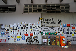 Graffiti and posters on a wall, Lockhart Road Market, Hennessy Road, Wanchai, 15 September 2019