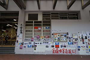 Graffiti and posters on a wall, Lockhart Road Market, Hennessy Road, Wanchai, 15 September 2019