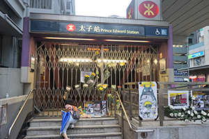 Posters and flowers at a makeshift shrine outside a closed Prince Edward MTR Station entrance, 1 September 2019