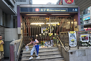 Posters and flowers at a makeshift shrine outside a closed Prince Edward MTR Station entrance, 1 September 2019