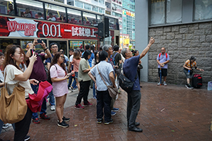 People outside a closed Prince Edward MTR Station entrance, 1 September 2019