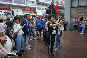 People taking photos outside a closed Prince Edward MTR Station entrance, Nathan Road, 1 September 2019