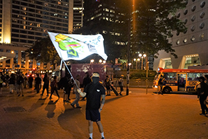 Protester waving a banner in Edinburgh Place, Central, 27 September 2019