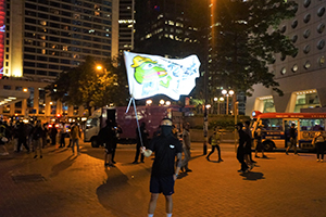 Protester waving a banner in Edinburgh Place, Central, 27 September 2019