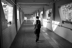 Student on a footbridge, Kwai Shing West Estate, New Territories, 18 October 2019