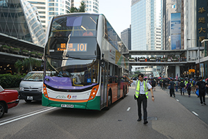 Bus company staff member diverting bus traffic, Connaught Road Central, 1 October 2019