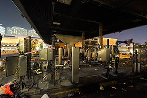 The vandalized and burnt toll plaza of the Cross-harbour tunnel, blocked to traffic by protesters, Hong Chong Road, Hung Hom, 16 November 2019