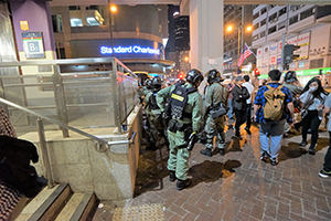 Police removing memorial items left outside an entrance to Prince Edward MTR station, Nathan Road, 16 November 2019