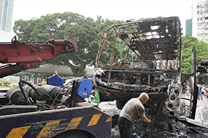Worker preparing to tow away a burnt-out coach, Nathan Road, Tsim Sha Tsui, 19 November 2019