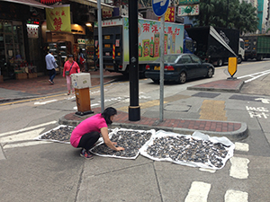 Woman drying produce on the street, Bonham Strand, Sheung Wan, 19 November 2019