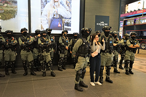 Posing for photos with police in riot gear, Canton Road, Tsim Sha Tsui, 26 December 2019