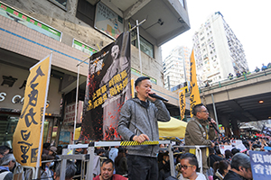 Raymond Chan Chi-chuen addressing marchers during a protest march from Causeway Bay to Central, Hennessy Road, 8 December 2019
