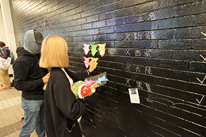 Protesters sticking origami pigs on a wall, rally in support of Spark Alliance, Edinburgh Place, Central, 23 December 2019