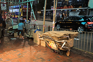 Woman sorting cardboard for recycling, Tin Hau, Hong Kong Island, 24 December 2019