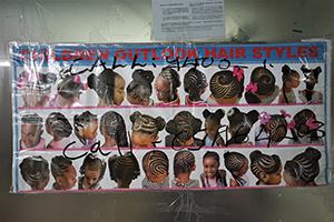Advertisement concerning African hairstyles, inside Mirador Mansion, Nathan Road, Tsim Sha Tsui, 26 December 2019