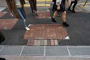 Asphalt covering areas where paving stones have been pried up during protests, Carnarvon Road, Tsim Sha Tsui, 26 December 2019