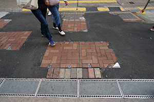 Asphalt covering areas where paving stones have been pried up during street protests, Carnarvon Road, Tsim Sha Tsui, 26 December 2019