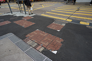 Asphalt covering areas where paving stones have been pried up during street protests, Tsim Sha Tsui, 26 December 2019