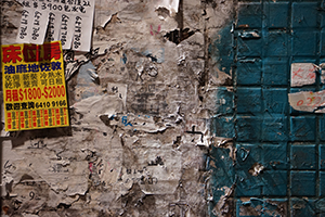 Torn posters and property advertisements on a wall, Mongkok, Kowloon, 26 December 2019