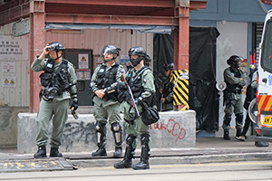 Police in riot gear outside a vandalized store, Johnston Road, Wanchai, 1 January 2020